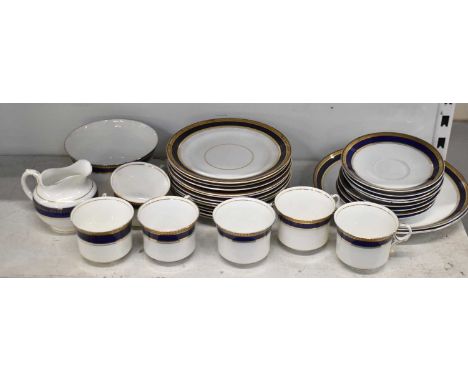 A Diamond China part tea service, comprising twelve side plates, two large plates, eight saucers, six teacups, sugar bowl and