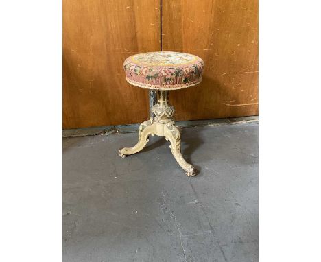 A Victorian white painted piano stool with tapestry cushion cover.
