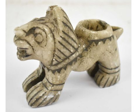 A Persian carved stone candlestick modelled as a dog, height 9.5cm, width 12cm. 