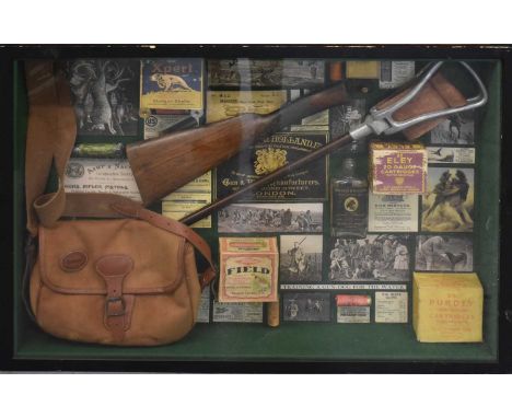 A decorative shooting/field sports diorama comprising shell boxes and cases, shooting stick, cartridge bag, hunting photograp