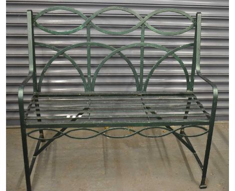 A green painted wrought iron garden bench, width 106cm.