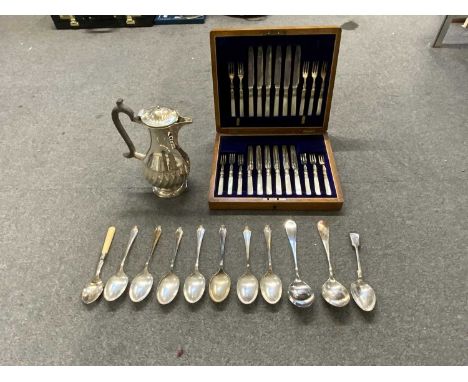 An oak cased set of mother of pearl handled dessert knives and forks (one fork absent), a plated water jug and a small quanti