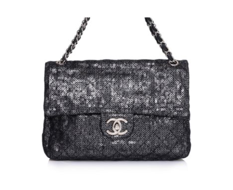 A CHANEL JUMBO BLACK QUILTED MESH FLAP BAG
Mesh fabric is quilted in a diamond pattern with an underlay of metallic sequins, 