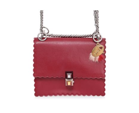 A FENDI RED KAN 1 HANDBAG
Red leather with scalloped edges, silver and gold-tone pyramid push-lock closure, and chain shoulde