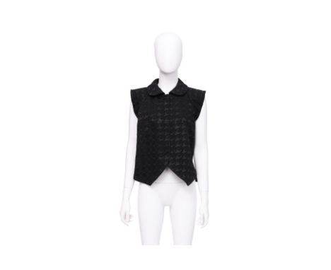 A BALENCIAGA BLACK SLEEVELESS VEST BY NICOLAS GHESQUIÈRE
Heavyweight fabric with a tonal houndstooth pattern, concealed snap-