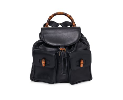 A GUCCI BAMBOO TOP HANDLE BACKPACK
Black leather with flap closure, dual adjustable leather shoulder straps, two front pocket