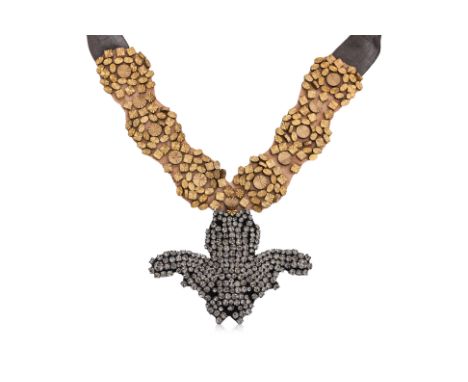 A VERA WANG CRYSTAL EMBELLISHED NECKLACE
Satin ribbon necklace with an antiqued brass floral-studded brand and a faceted crys