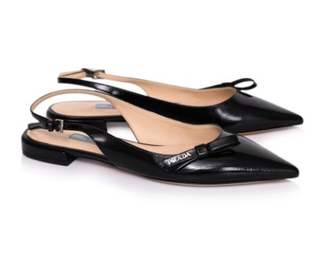 A PAIR OF PRADA PATENT LEATHER SLINGBACKS
Pointed-toes with bow accents, strap and buckle fastening, and leather sole
Size 37