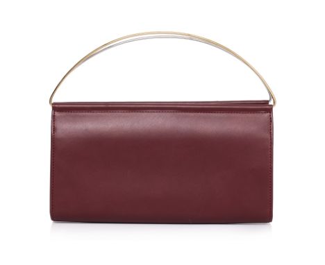 A CARTIER TRINITY TOP HANDLE HANDBAG
Burgundy leather dual-tone metal top handles in gold and silver-tone, fold-over flap clo