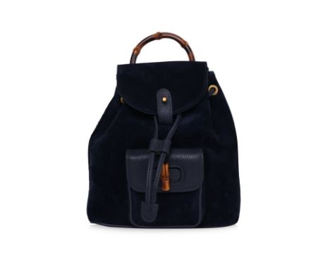 A GUCCI BAMBOO TOP HANDLE MINI BACKPACK
Blue suede and leather backpack with drawstring closure, flap with snap-button fasten