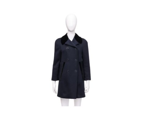 A LOUIS VUITTON NAVY WOOL TRENCH COAT
Mid-length with a structured double-breasted silhouette, contrasting velvet peak lapels