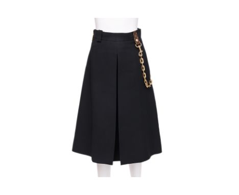 A LOUIS VUITTON PLEATED WOOL SKIRT BY NICOLAS GHESQUIÈRE
Featuring a structured A-line silhouette, detailed with a monogram-c
