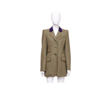 AN HERMÈS HOUNDSTOOTH CASHMERE RIDING JACKET
Circa 1980's, featuring a contrast purple velvet collar, single-breasted button 