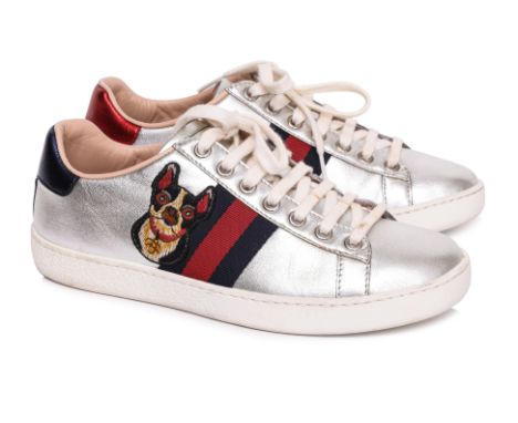 A PAIR OF GUCCI ACE 'YEAR OF THE DOG' SILVER SNEAKERS
Silver leather featuring a signature web stripe with an embroidered dog