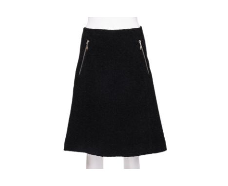 A LOUIS VUITTON BLACK BOUCLÉ SKIRT
With asymmetric zip pockets, back zip closure
Size 38
Ownership Statement: This item is of
