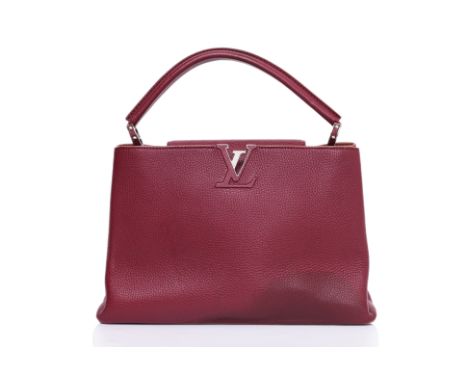 A LOUIS VUITTON BURGUNDY CAPUCINES MM HANDBAG
Clemence leather in burgundy, featuring a signature LV logo plaque, and single 