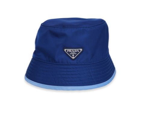 A PRADA BLUE NYLON BUCKET HAT
Featuring an enamel triangle logo plaque affixed to the front
Size S
Ownership Statement: This 