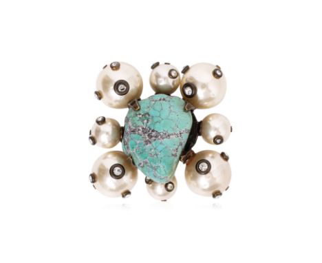 A CHANEL TURQUOISE AND FAUX PEARL BROOCH
Featuring a central raw turquoise cabochon, encased in an antiqued bronze metal sett