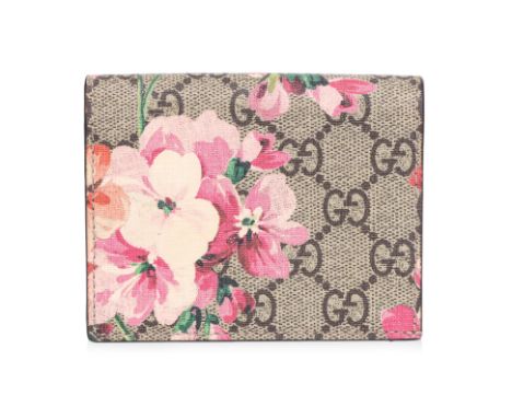 A GUCCI GG FLORAL PRINT WALLET 'GG' monogram coated canvas in beige with a floral pattern overlay, features a flap closure op