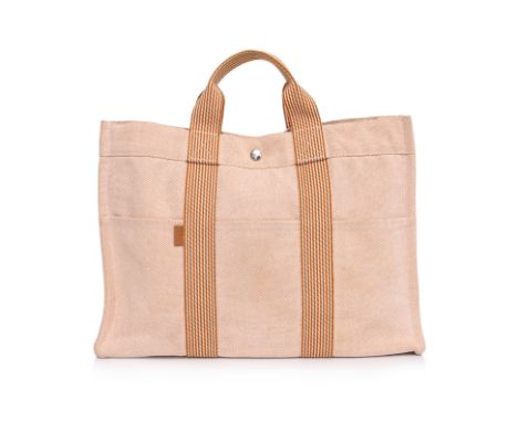 AN HERMÈS 'TOTO' CANVAS BAG
Salmon pink cotton canvas, structured silhouette with double top handles, press-stud fastening, m