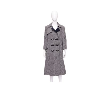 A LOUIS VUITTON TWEED TRENCH COAT
Herringbone tweed with an asymmetric lapel, toggle front closures, contrast undercollar, an