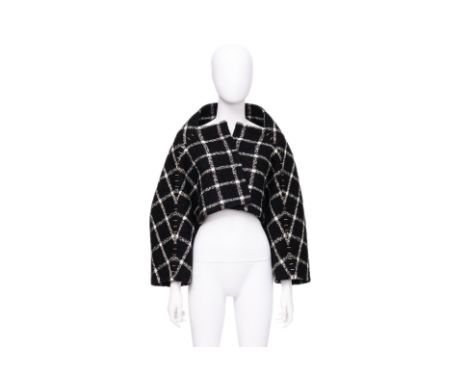 A BALENCIAGA CROPPED WOOL JACKET
Black and white windowpane check with oversized staple embellishments, boxy silhouette with 