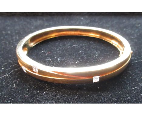Boodles "Kit and Kaboodle" 18ct yellow gold bangle set with three princess cut diamonds on a hinged band with box clasp and s