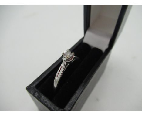 Hallmarked 9ct white gold diamond solitaire ring with a round cut diamond, claw set in twisted claw mount by SG, London, 375,