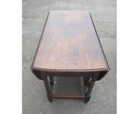 C20th oak gate legged table, with two D shaped leaves on barley twist and block supports joined by stretchers, W102cm, D148cm