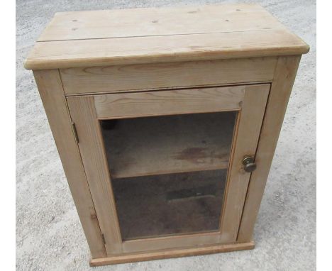 Small pine cupboard, with glazed door and single shelf on plinth base W66cm D38cm H86cm 