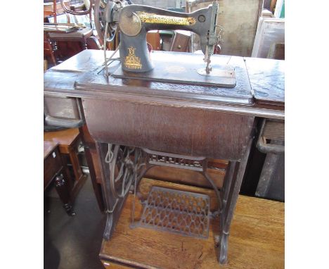 Vintage Singer treadle sewing machine on cast iron and oak base, no. Y7204562, with accessories and hire agreement dated 1930