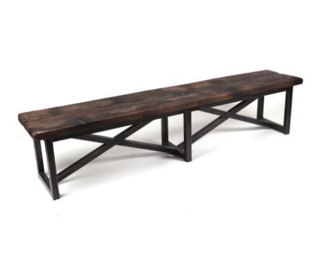 A Timothy Oulton Axel bench with double 'X' frame supports, made from reclaimed wood from decommissioned Chinese fishing junk
