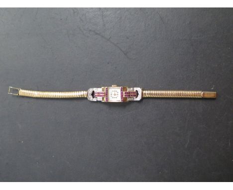 A diamond, ruby and gold odeonesque ladies wristwatch, the square face with arabic numerals in a raised case delineated by li