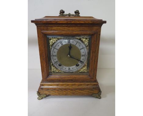 A nice quality bracket clock by W and H oak case with lion head decoration brass dial with silver chapter ring strikes quarte