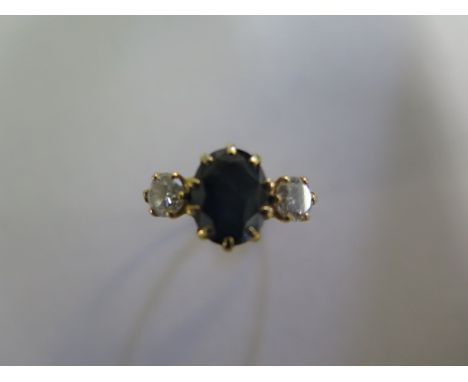 An 18ct yellow gold sapphire and diamond three stone ring, size J/K, sapphire approx 8mm x 7mm x 4.5mm, some wear to shank an