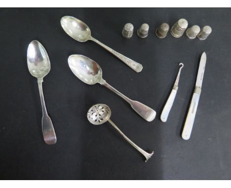 Three silver spoons, a sifter, a silver bladed button hook and a fruit knife and four silver thimbles and two others, total w