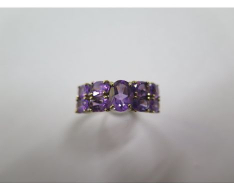 A hallmarked 9ct yellow gold nine stone amethyst ring, size Q, in good condition 