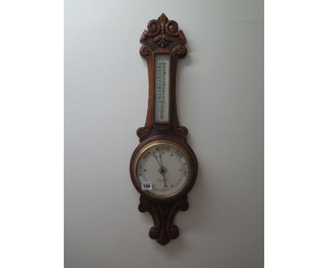 An oak barometer and thermometer, 74cm tall 