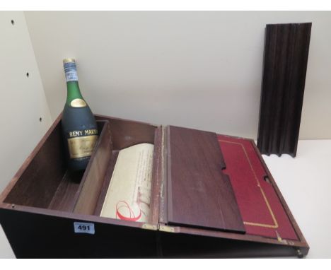 A Remy Martin Cognac V.S.O.P 50cl bottle in a presentation writing slope 