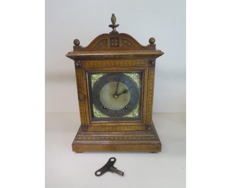 A walnut inlaid mantle clock with a W&amp;H Sch movement, striking on two gongs, 34cm tall, with key, generally good minor ve
