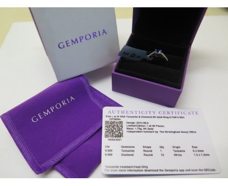 A 9ct yellow gold tanzanite and diamond ring, round tanzanite 6mm x 6mm, in unworn condition with certificate and pouch and b