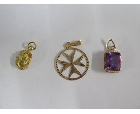 An 18ct yellow gold pendant 22mm wide and an Egyptian gold scarab pendant, total weight approx 2.2 grams, and another amethys