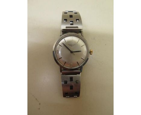 A Longines stainless steel manual wind wristwatch on a sports bracelet, 34mm case, in running order, hands advance, some usag