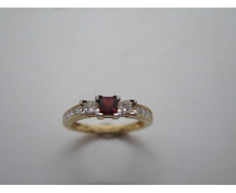 A good hallmarked 18ct yellow gold ruby and diamond 11 square cut stone ring, the ruby approx 4mm x 4mm, 2.7mm, size N, in go