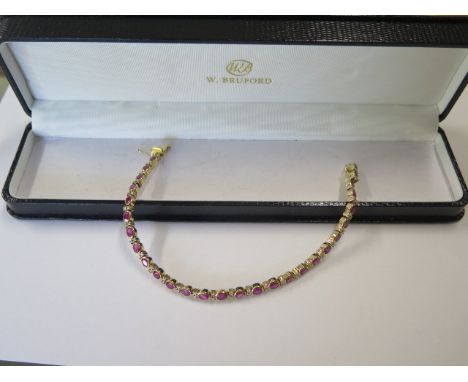 An 18ct yellow gold ruby and diamond bracelet, 20cm long, approx 19.2 grams, marked 750, in good condition 
