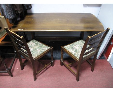 An Ercol Style Refectory Dining Table, and two associated ladder back chairs. 