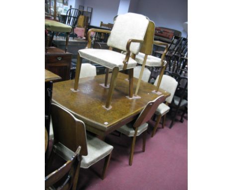 A 1920's Walnut Dining Table, the oval top with moulded edge, on twin pedestals, 80cm high, 74cm wide; eight matching dining 