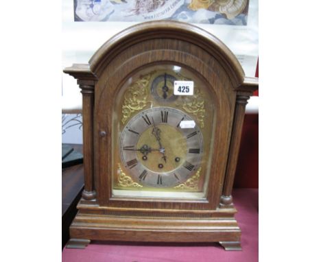 A Gustav Becker Late XIX Century German Oak Cased Mantel Clock, with an arched top, silvered chapter ring, Roman numerals, su