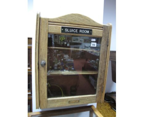 An Oak Washroom Wall Cabinet, circa 1920's with glazed door bearing brass label "The Initial Tower Supply Co. Goswell RD. E. 