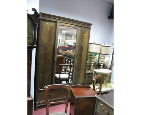 A 1920's Mahogany Double Wardrobe, with stepped cornice, mirrored door and single drawer base, a matching six drawer dressing